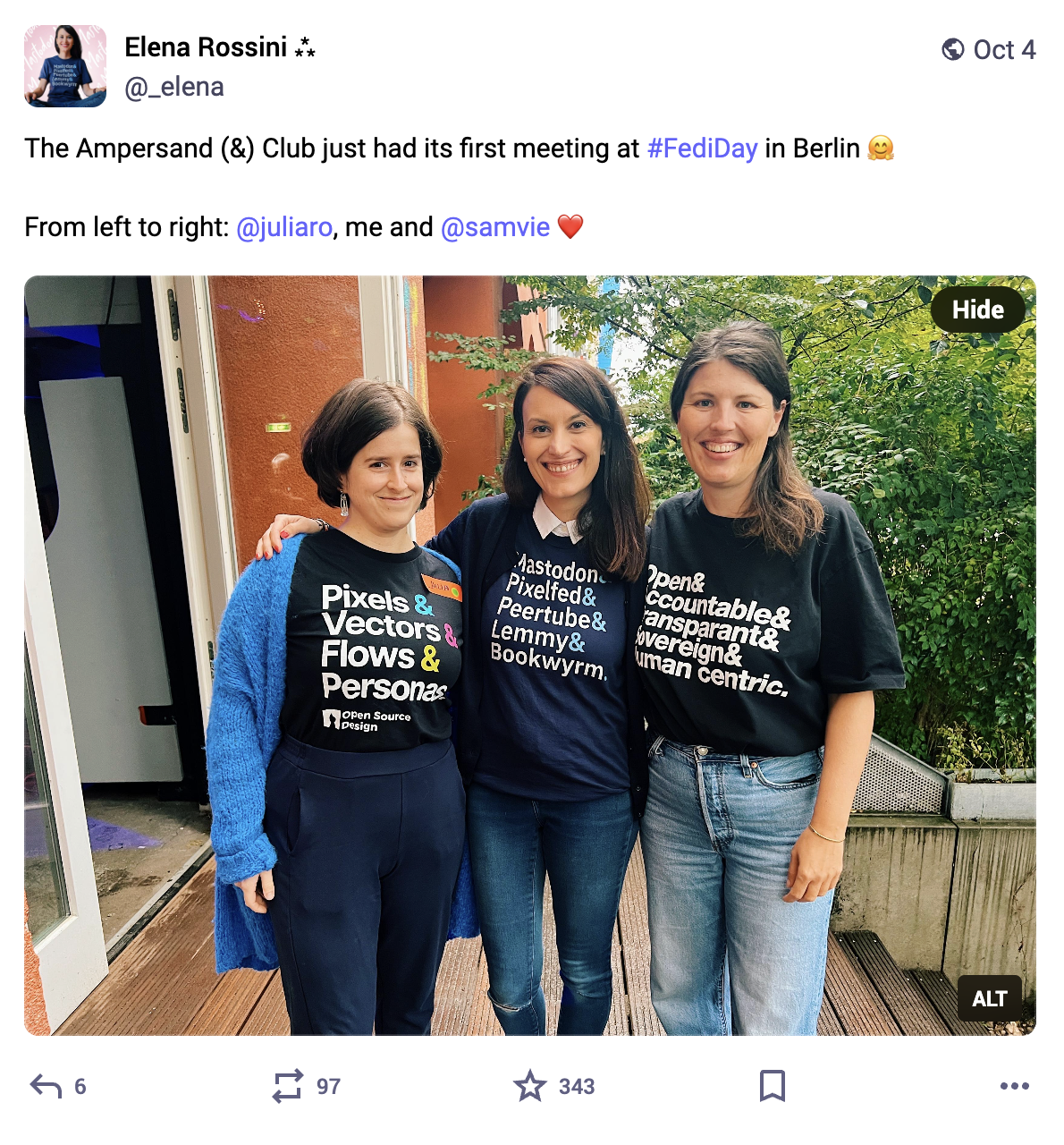 the screenshot of a toot that reads "The Ampersand (&) Club just had its first meeting at #FediDay in Berlin. From left to right: @juliaro, me and @samvie". The photo shows  three women: Julia wearing the t-shirt Pixels & Vectors & Flows & Personas… me wearing the t-shirt Mastodon & Pixelfed & Peertube & Lemmy & Bookwyrm… and Samvie wearing the t-shirt Open & Accountable & Transparent& Sovereign & Human Centric
